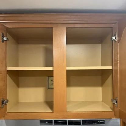 Clean empty kitchen cabinet interior