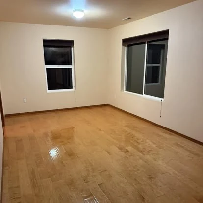 Clean empty room with polished hardwood flooring
