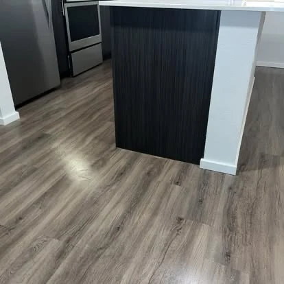 Freshly cleaned flooring around a modern kitchen island