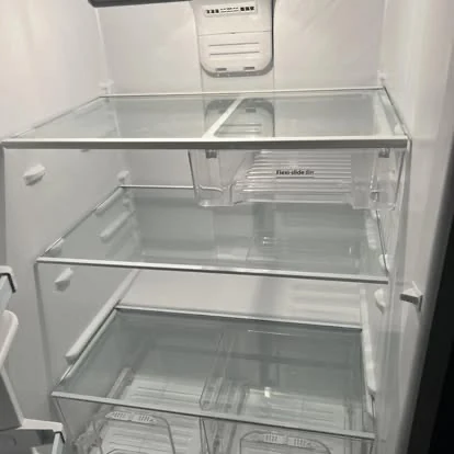 Spotless refrigerator interior with clean glass shelves and drawers