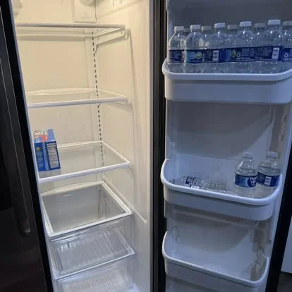 Clean refrigerator interior with shelves and door compartments detailed