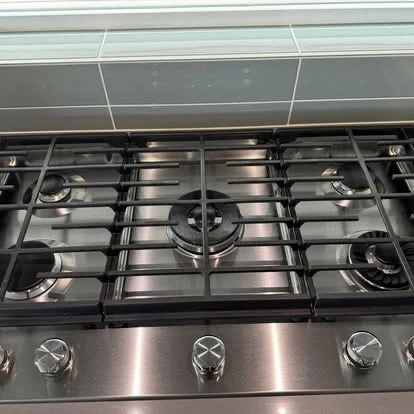 Detailed stainless steel gas cooktop after cleaning